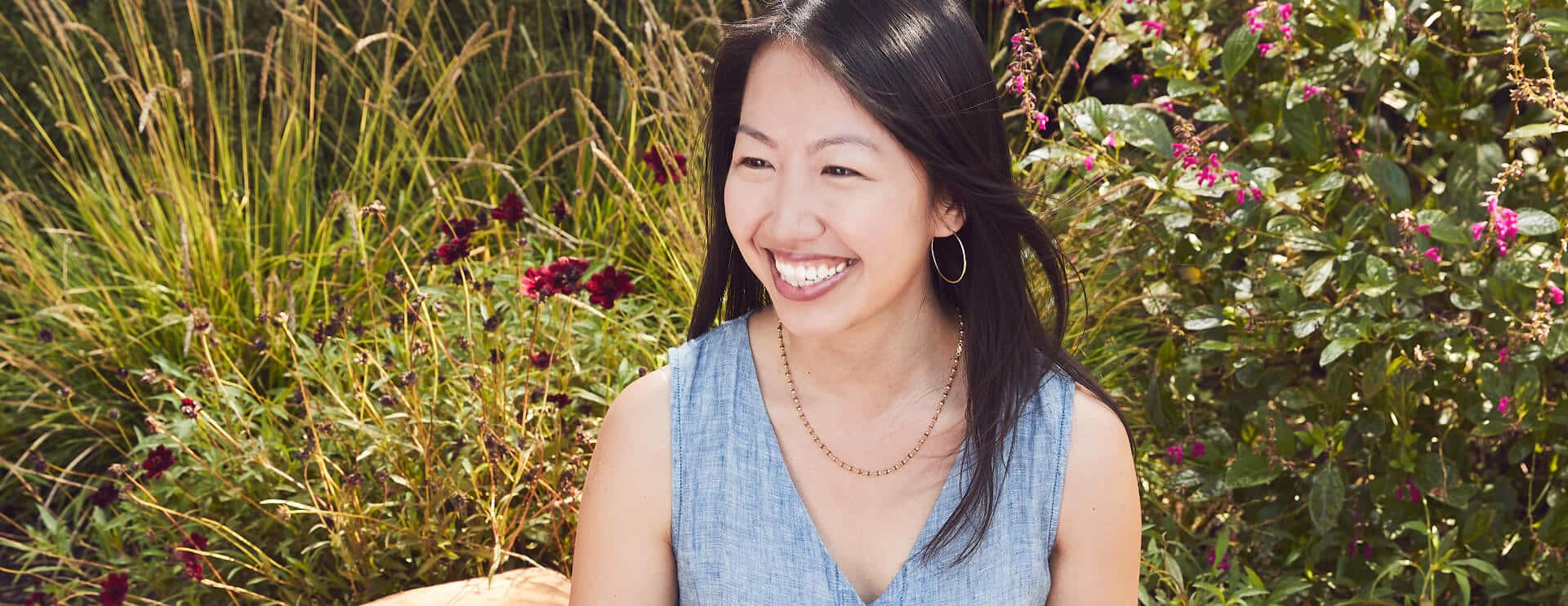 Photo of Susan sitting in a garden